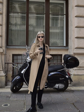 a lady wears a woolen double-breasted trench coat